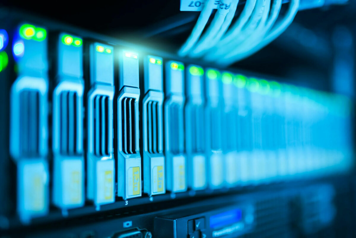 A close up of a server rack filled with tangled wires.